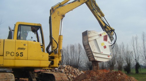 crusher bucket crushing rock at demolition site