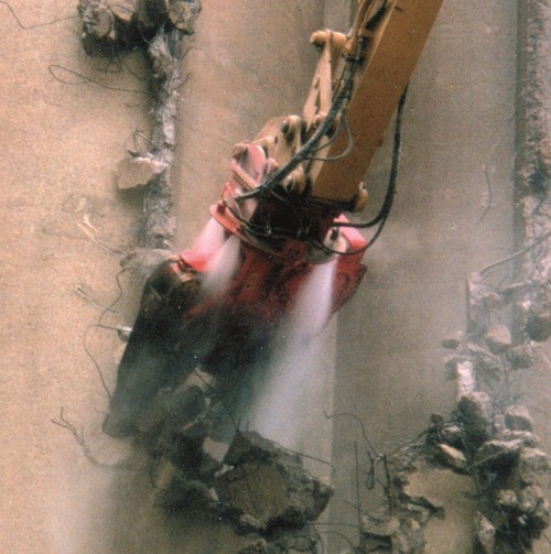 Dynaset Dust Suppression System spraying from a grab at a demolition site