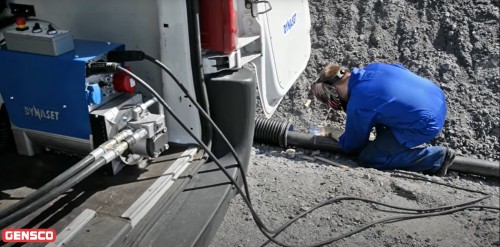 man welding steal pipe using hydraulic welder generator