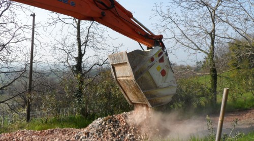 crusher bucket crushing rock at demolition site