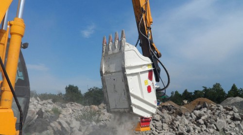 crusher bucket crushing rock at demolition site