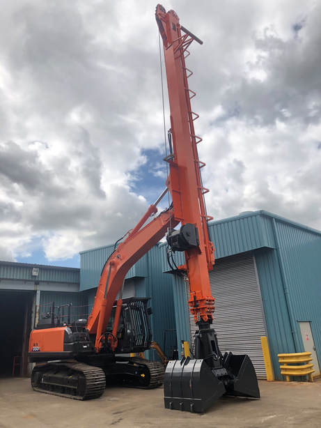 orange excavator with long telescopic teledipper arm attached to it