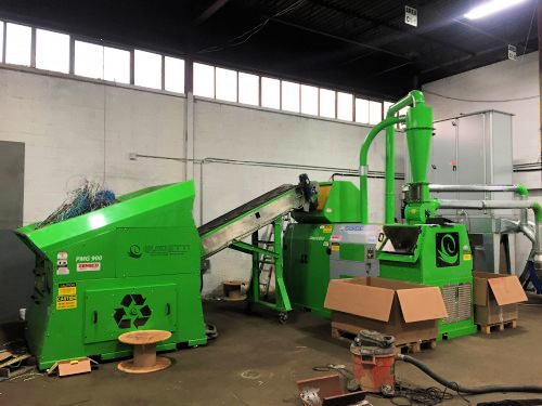 Green pre shredding machine and conveyer sending wire to granulator separator machine.